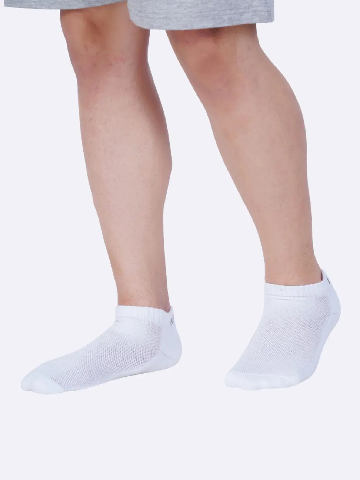 Pair of low ankle socks in a neutral color, designed to cover the foot and ankle for comfort and breathability.
